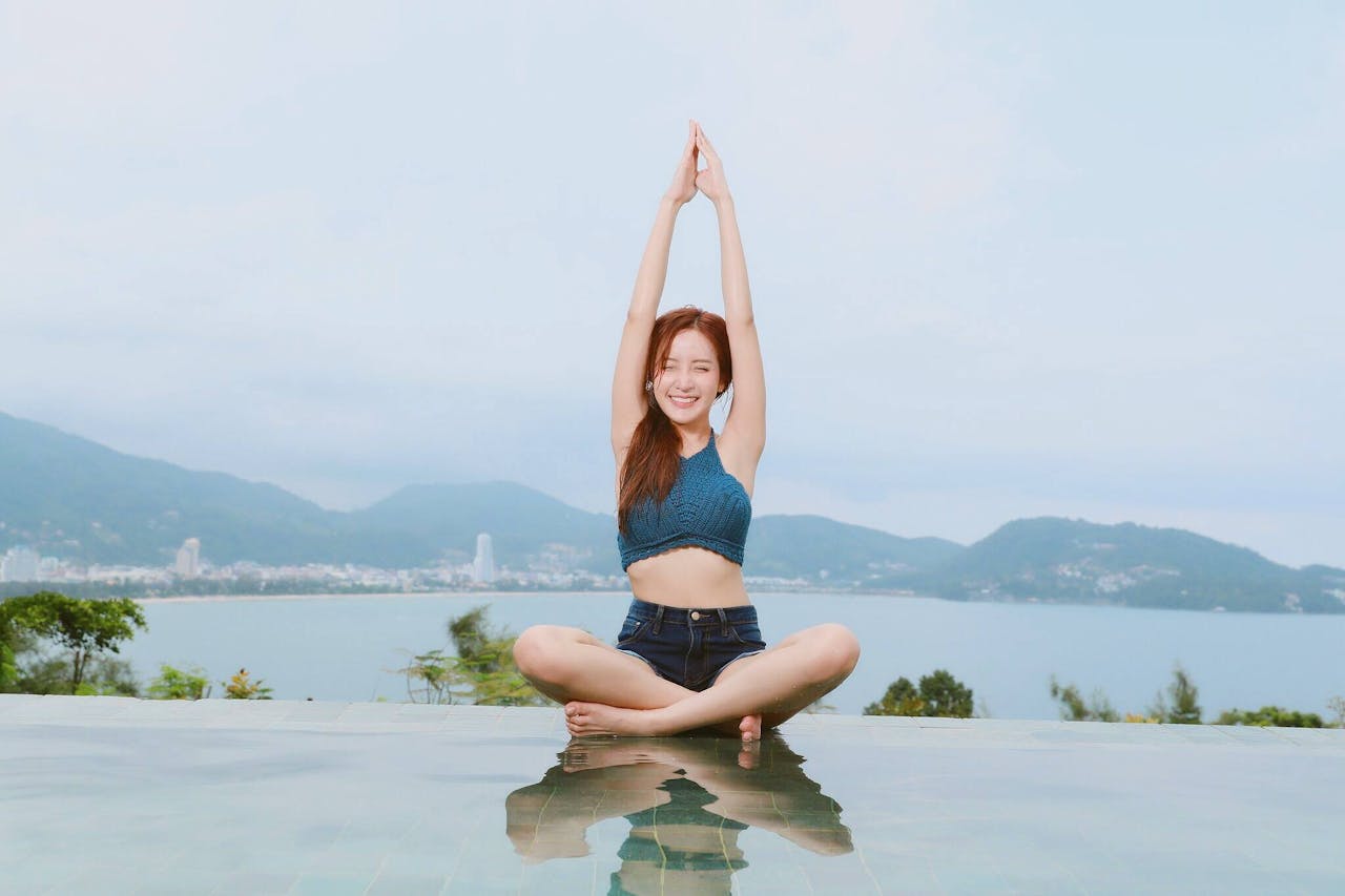 Woman Doing Yoga on Poolside